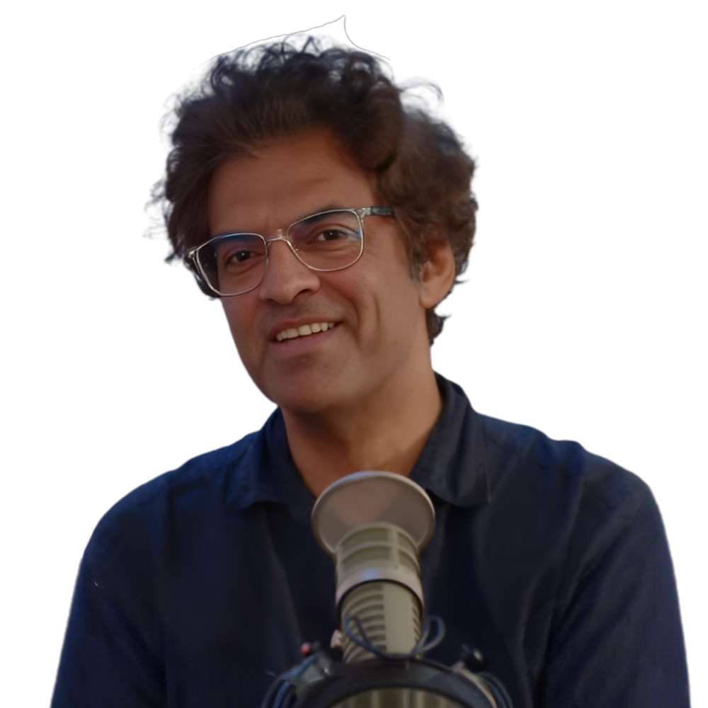 A portrait of Mal smiling in a studio